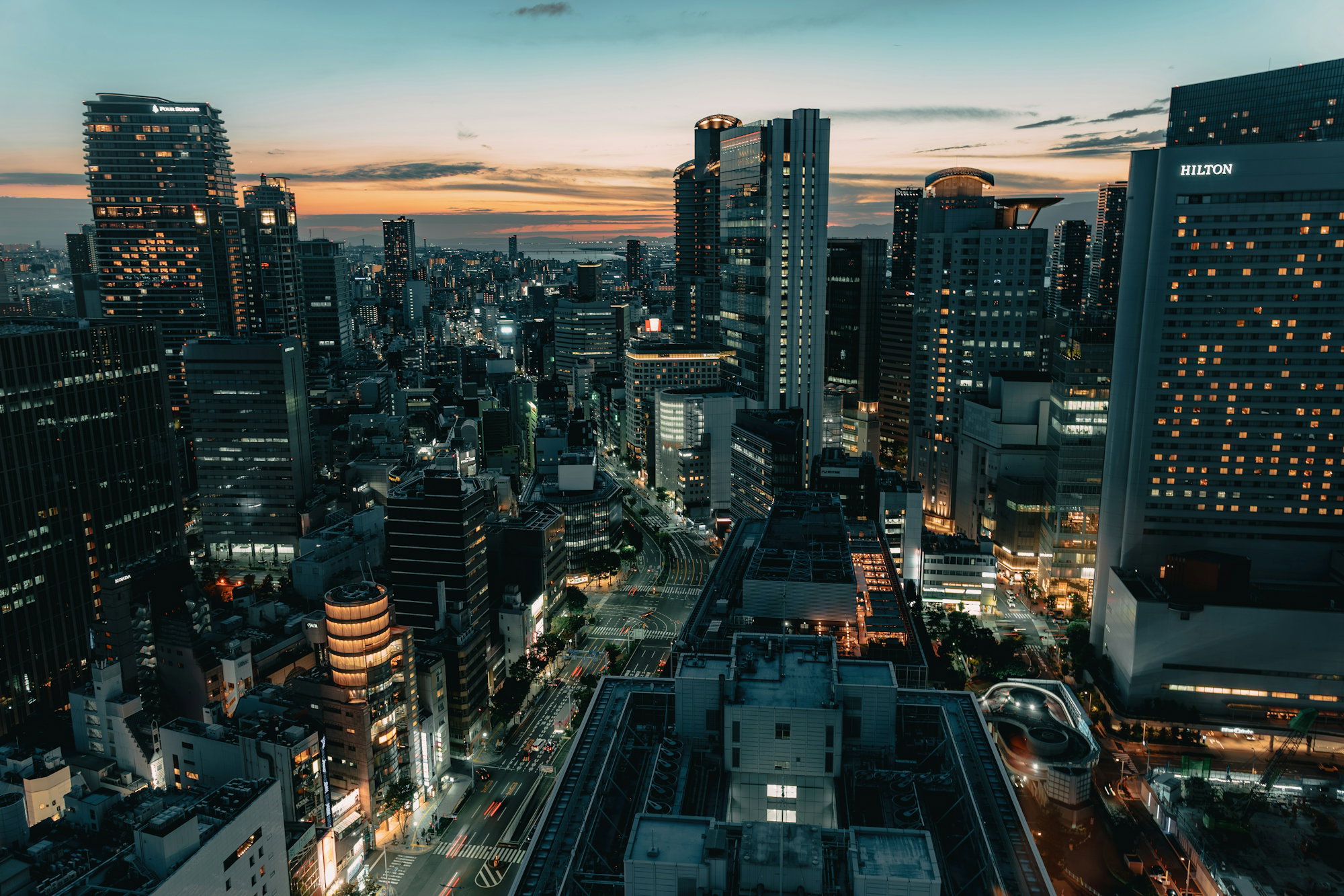 aerial-view-of-the-osaka-skyline-at-night-with-illuminated-skyscrapers-and-busy-streets.jpg Aerial view of the Osaka skyline at night with illuminated skyscrapers and busy streets